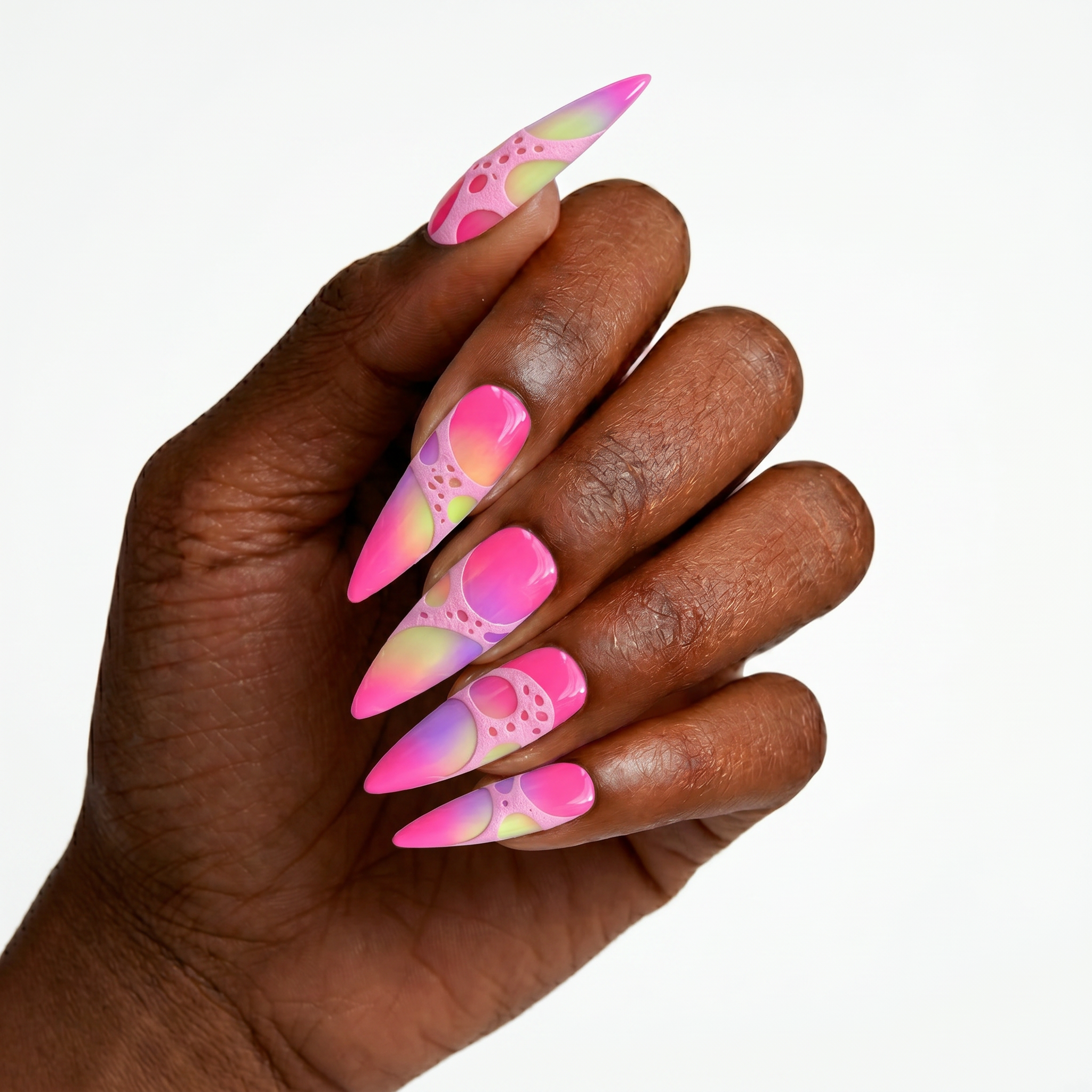 High-gloss press-on nails with neon pink, green, and purple gradients under a textured pastel pink 3D cellular overlay.