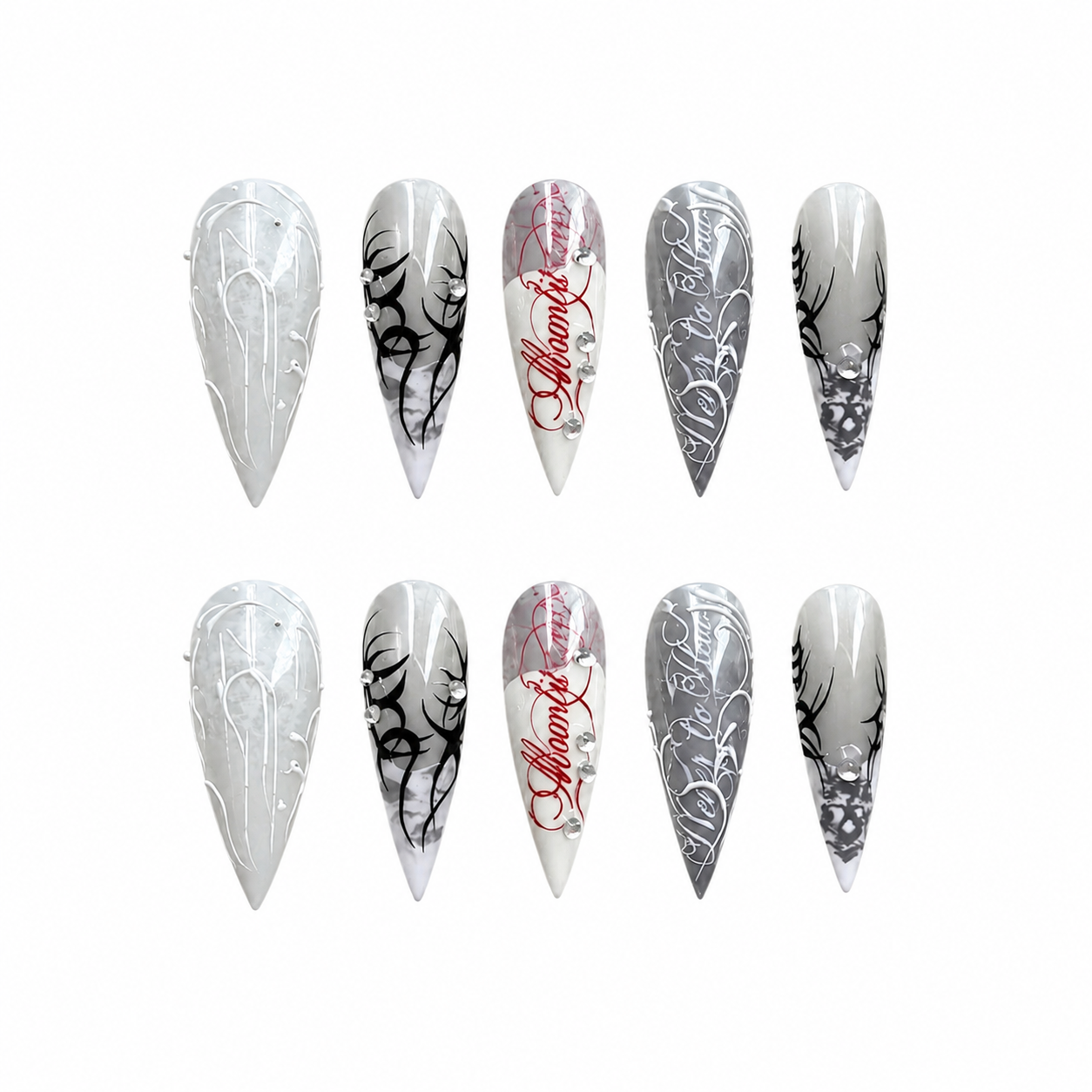 Glossy stiletto press-on nails with grey gradient bases, black tribal patterns, white 3D gothic script, and red calligraphy.