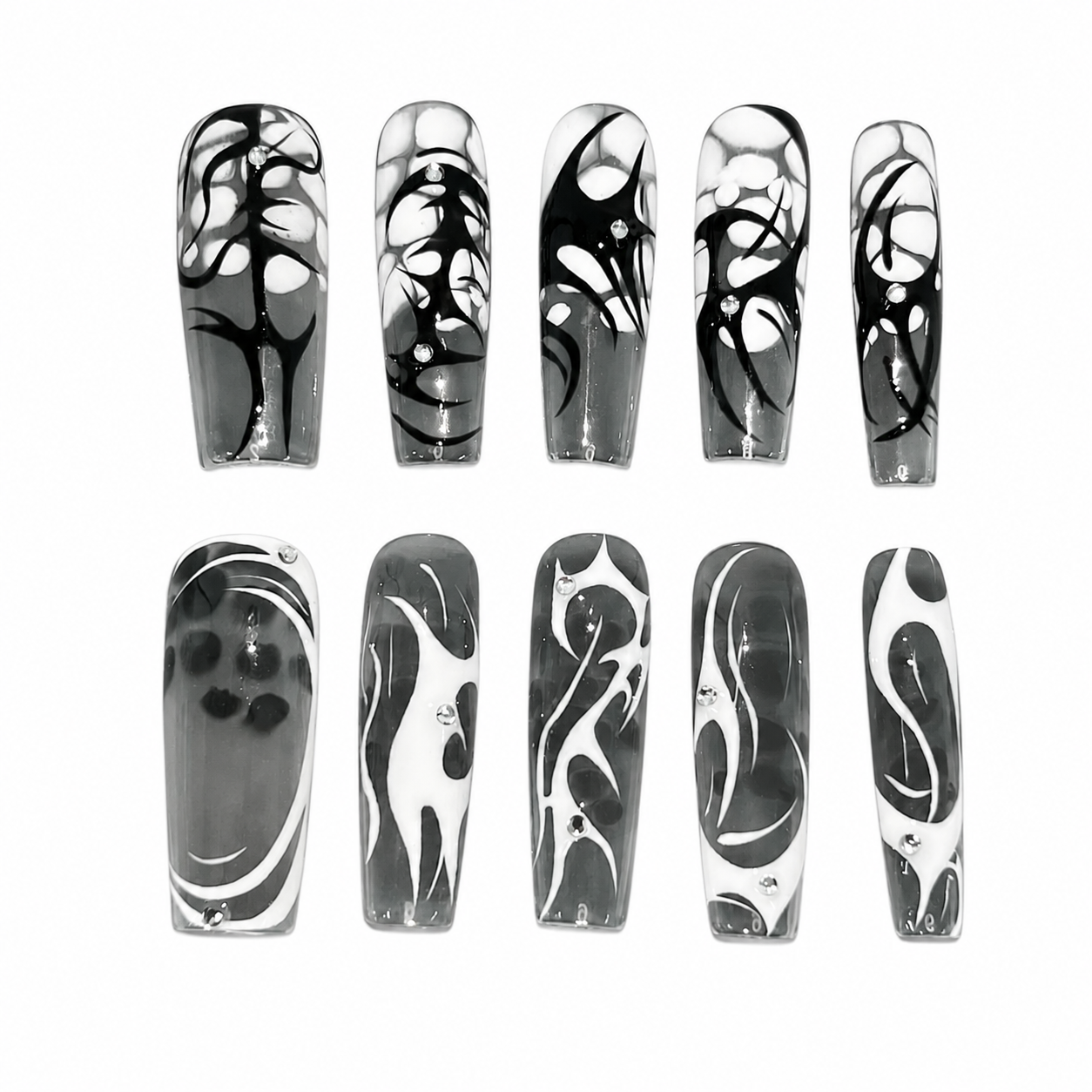 Glossy coffin press-on nails with a smoky translucent grey base, hand-painted black and white cyber tribal thorns, gothic liquid fluid lines, and tiny rhinestones.
