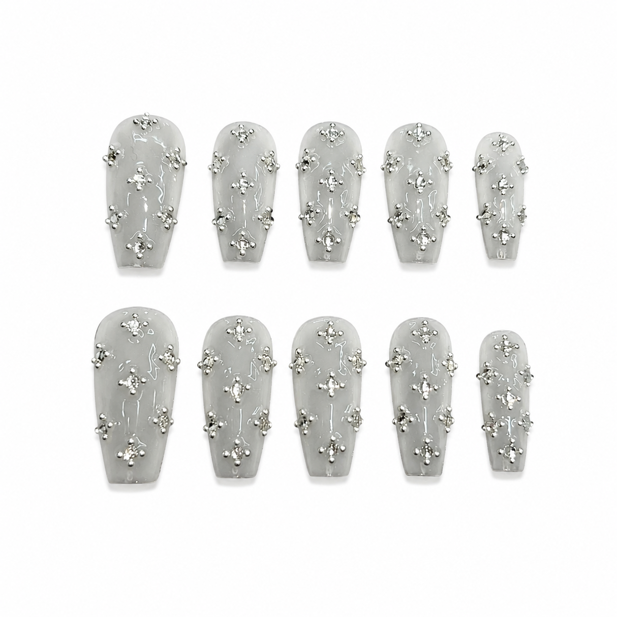 Glossy coffin press-on nails with a semi-translucent jelly grey base, silver gothic cross rivets, rhinestones, and miniature metal studs.
