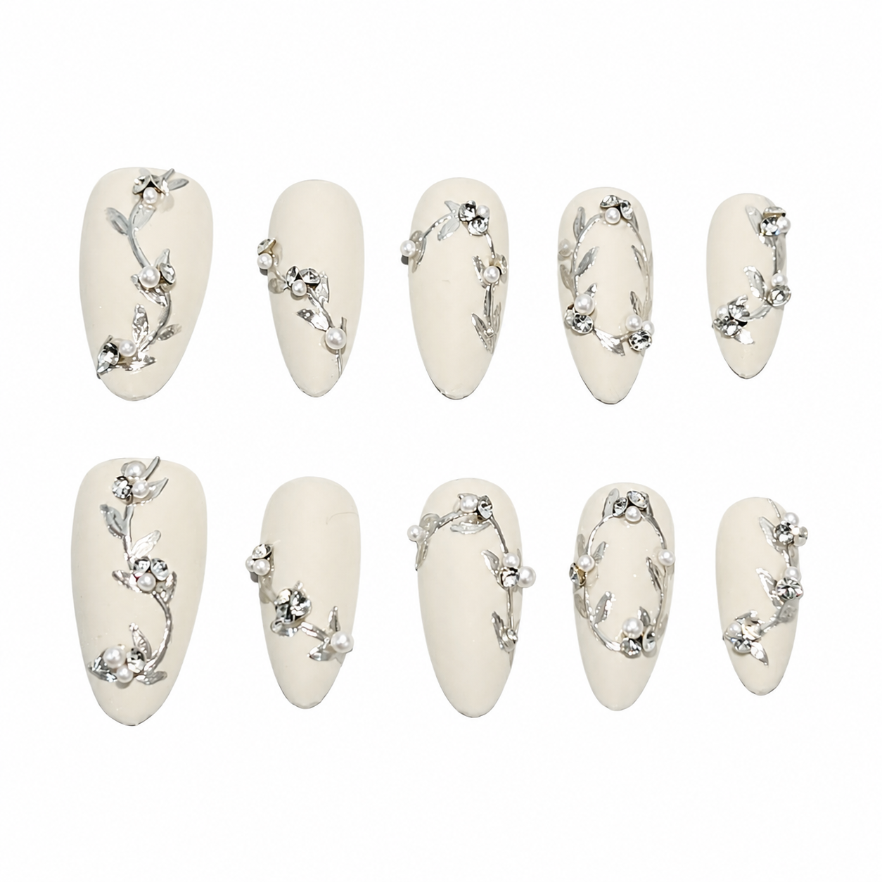 Glossy aurora-chrome press-on nails with a milky white base, decorated with 3D silver floral vines, pearls, and rhinestones.