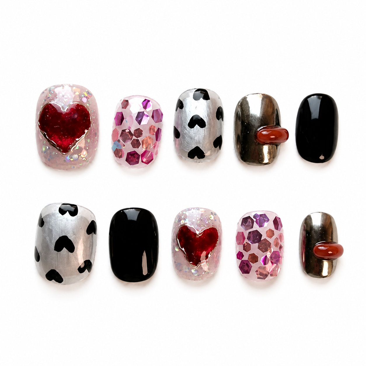 Glossy press-on nails featuring silver chrome and black bases decorated with pink hex glitters, hand-painted mini hearts, and a 3D ruby heart framed in liquid gold chrome.