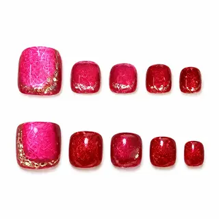 Vibrant hot pink press-on toe nails with a gold glitter accent at the base, colorful summer pedicure style