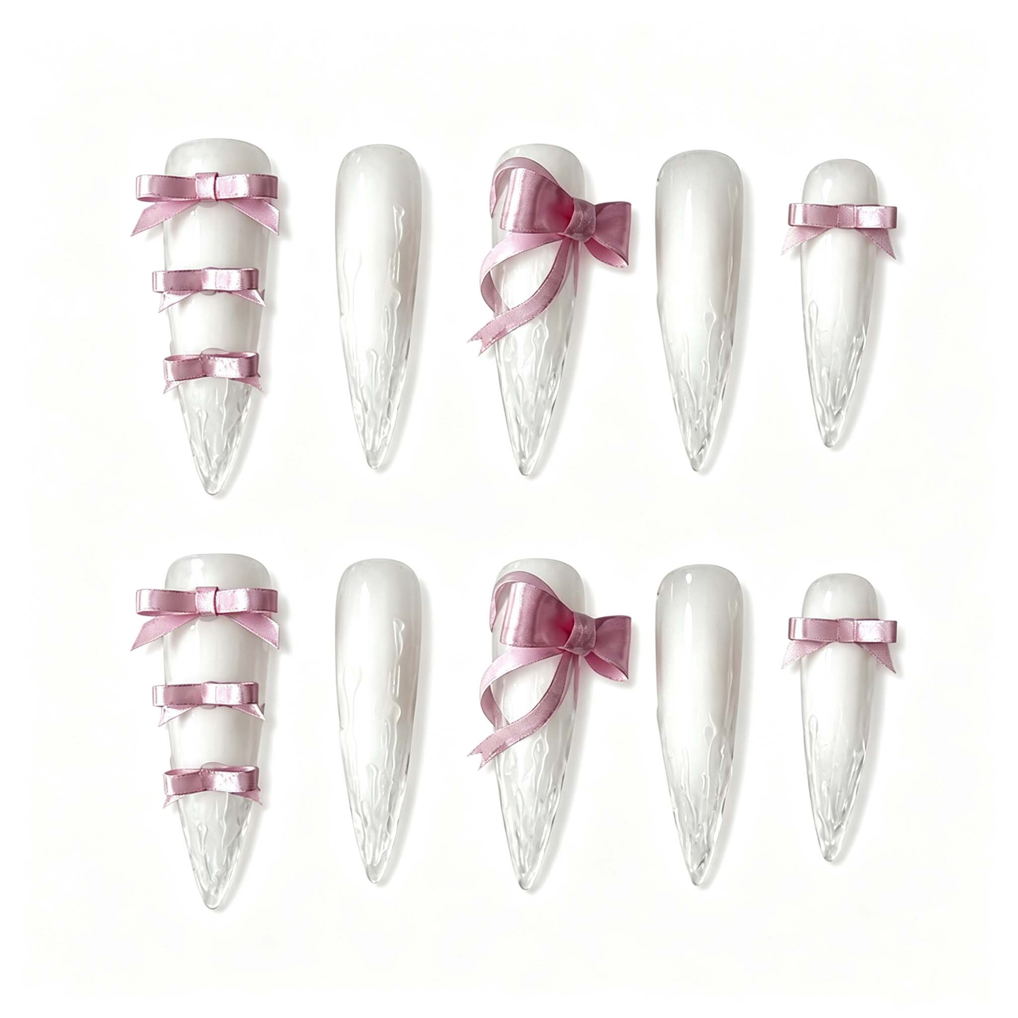 Frosted white stiletto press-on nails featuring realistic 3D melting icicle texture and dusty pink satin ribbon bows.