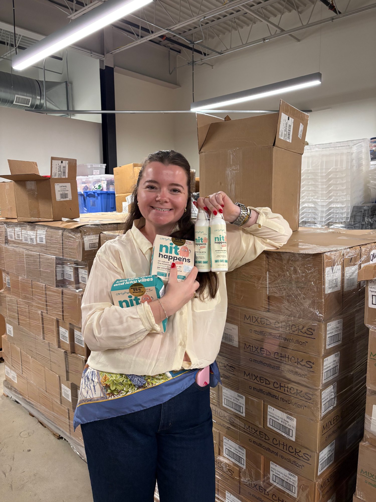 Holding Nit Happens products from Cartwheel's donation to the Wonderfund