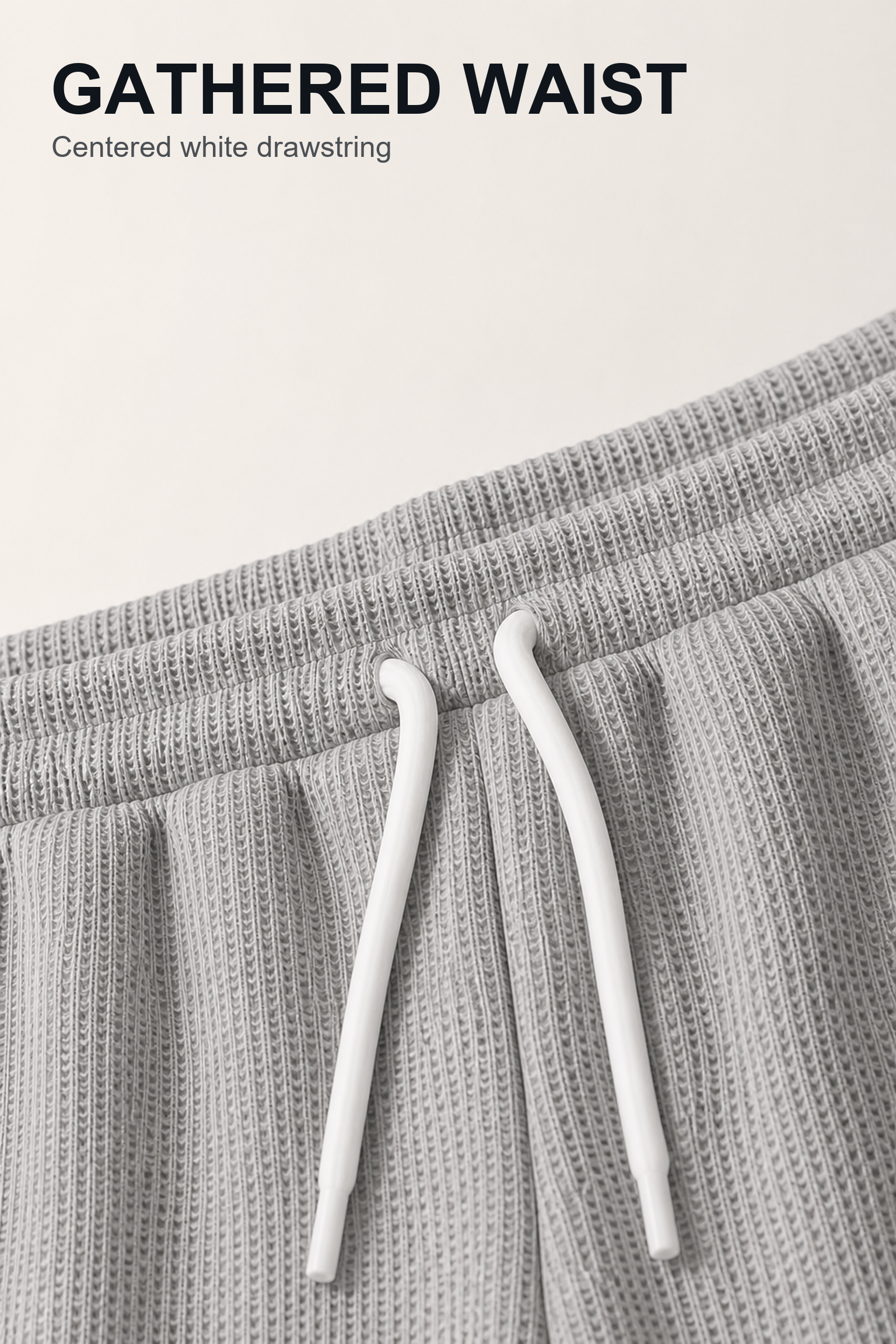 Close-up of gathered waistband with centered white drawstring