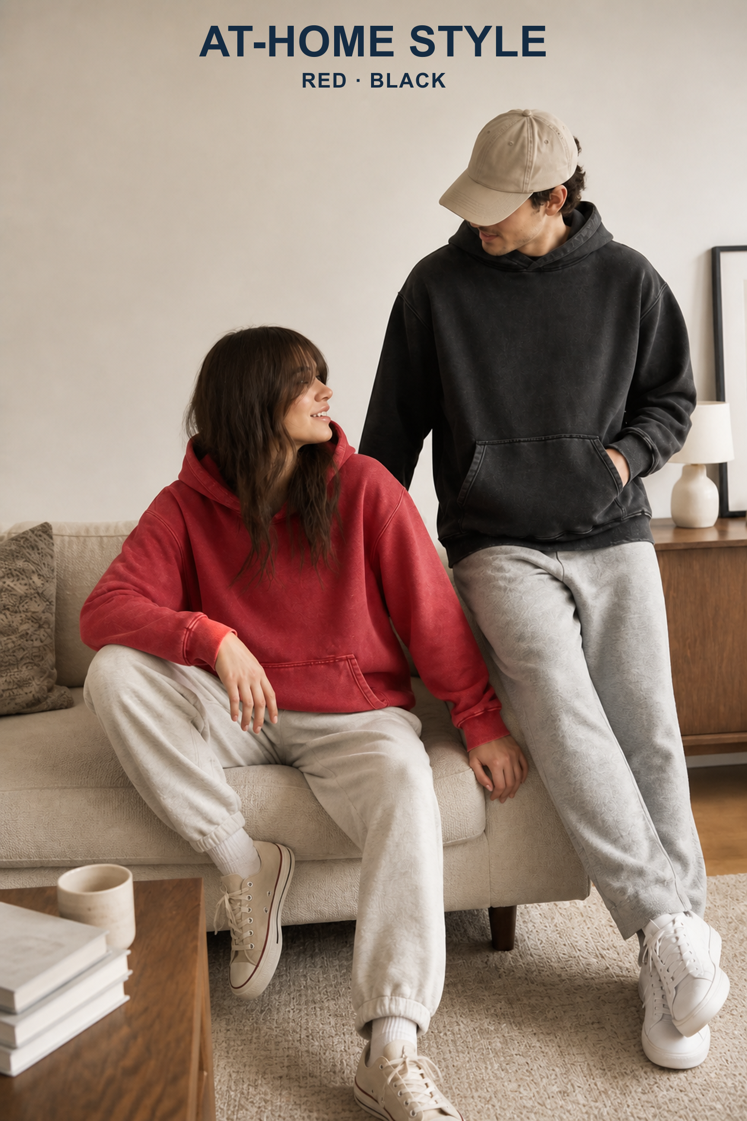 Adults wearing Red and Black washed pullover hoodies in a balanced American apartment scene