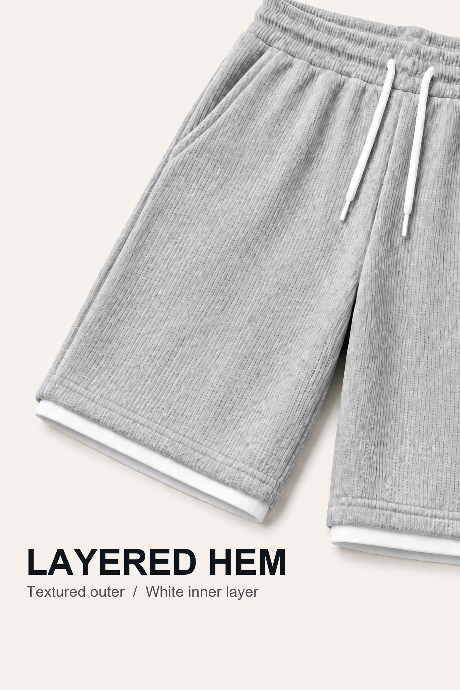 Close-up of knee-length shorts showing textured outer hems and white inner layer