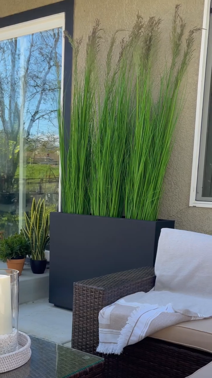 Beautiful privacy screen with miscanthus plant & planters lit up at night with solar lights-Aldronix