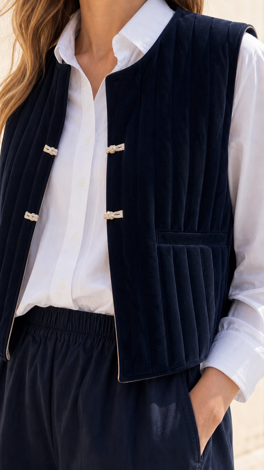 Close-up of Navy quilted vest texture and toggle closures