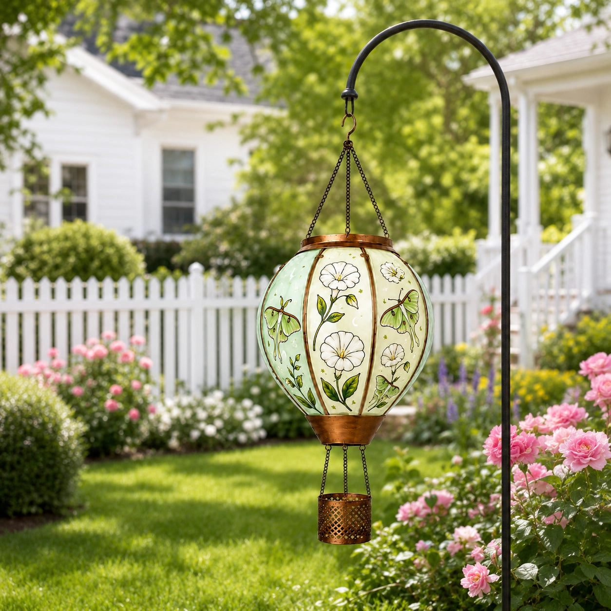 Butterfly flower hot air balloon solar lantern hanging in a garden with hand-painted glass design