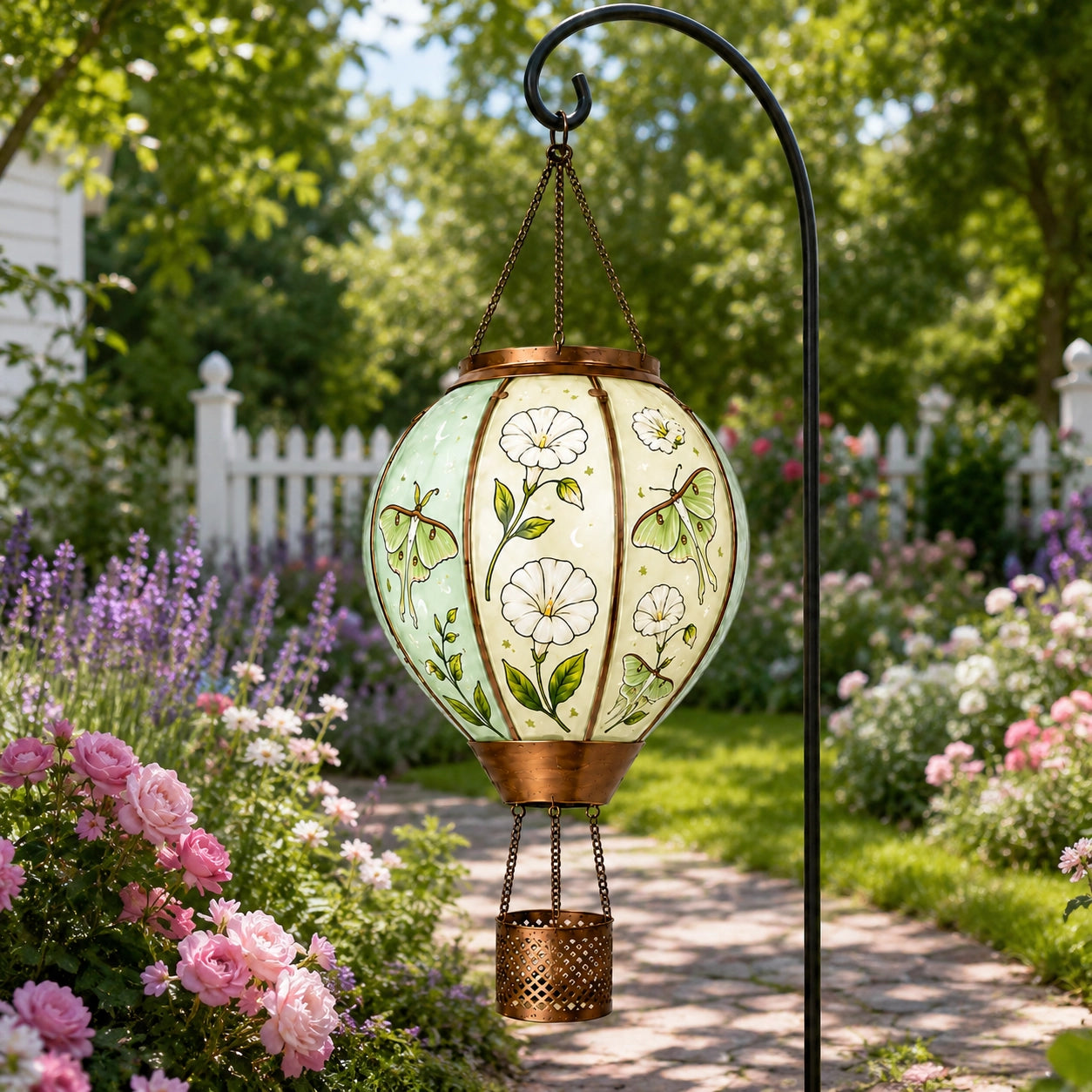 Butterfly hot air balloon solar garden light decorating a flower pathway outdoors