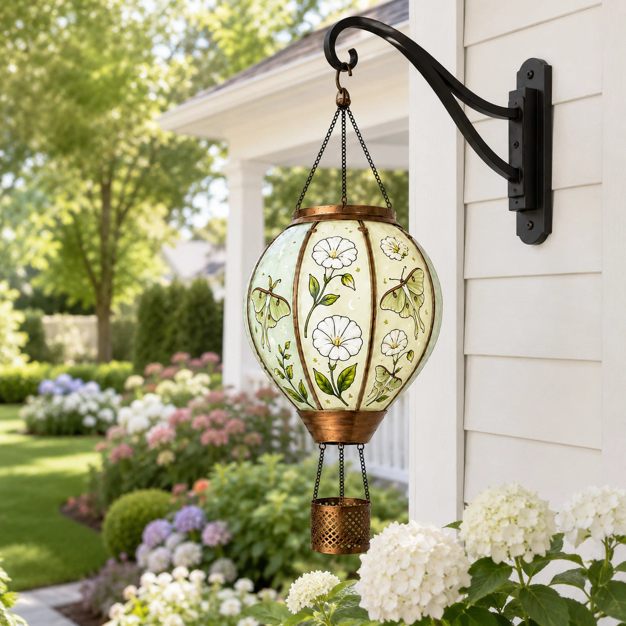 Hand-painted butterfly solar lantern hanging beside a house wall for outdoor garden decoration