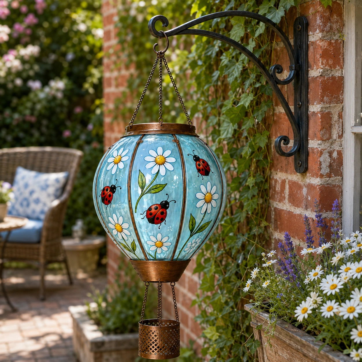 Hand painted ladybug hot air balloon solar lantern hanging beside brick wall