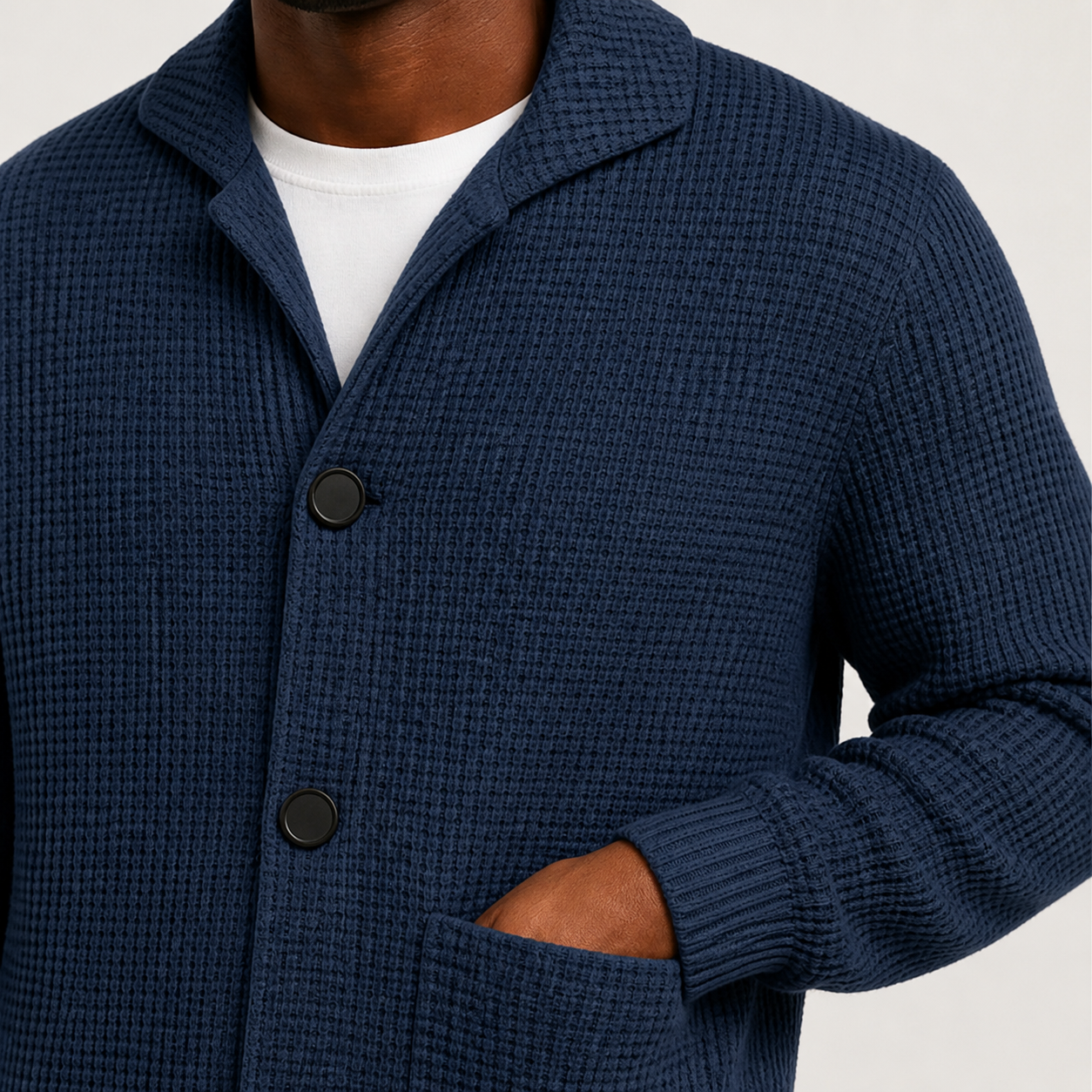 Close view of the Navy men's textured waffle knit cardigan surface and visible front details