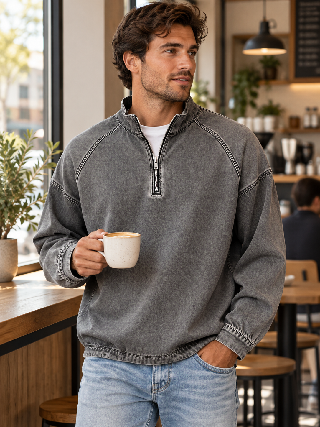 Charcoal grey vintage washed quarter-zip pullover worn at a neighborhood cafe