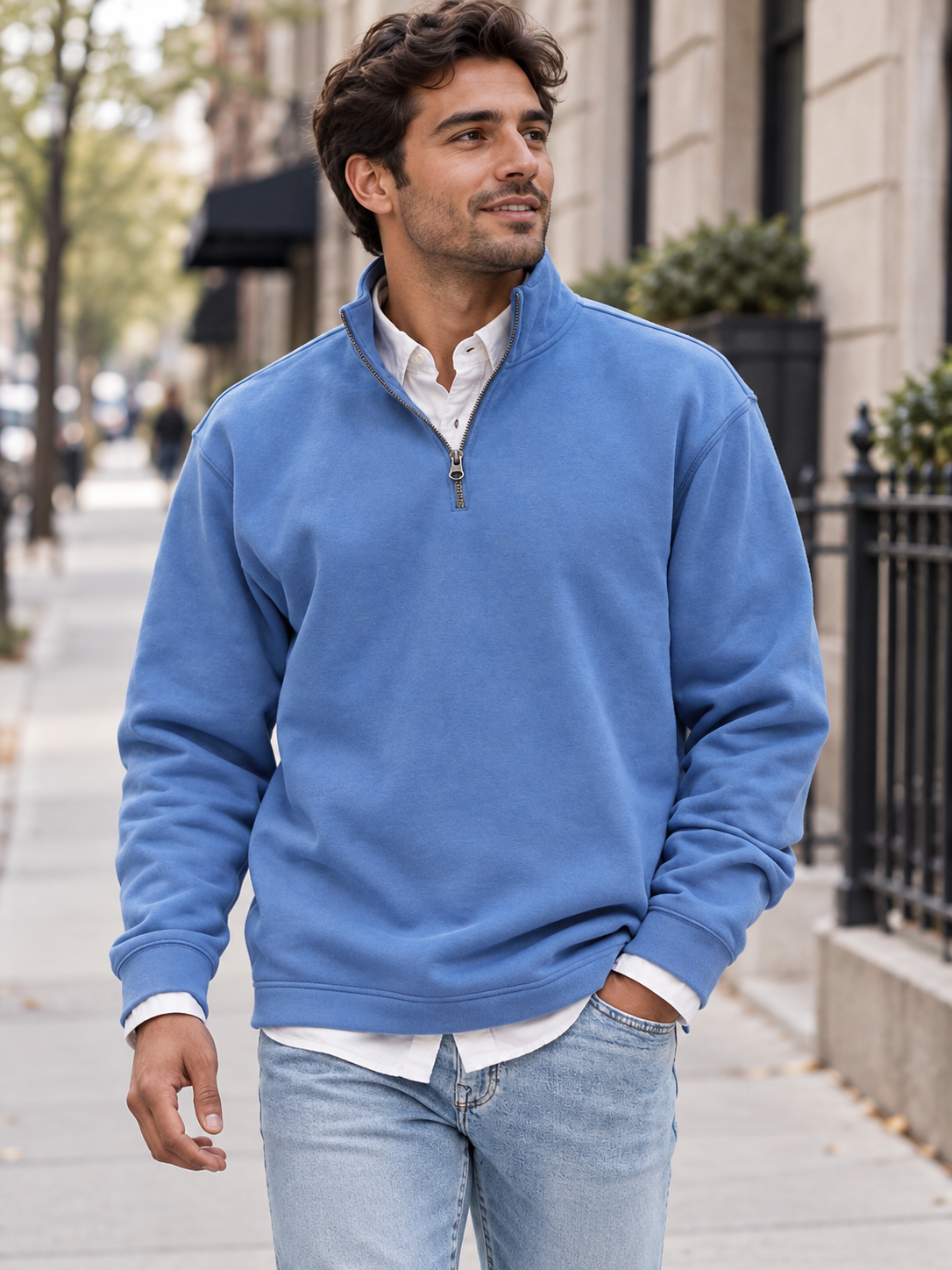 Blue quarter-zip sweatshirt worn on a city walk