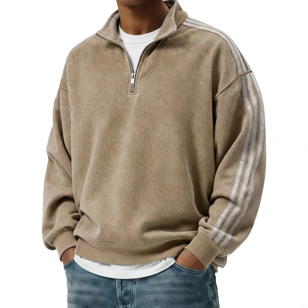 Close view of the quarter zipper, stand collar, and striped sleeves
