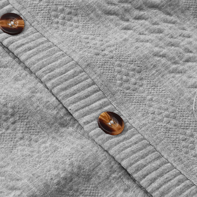 Close view of button and cable-knit texture