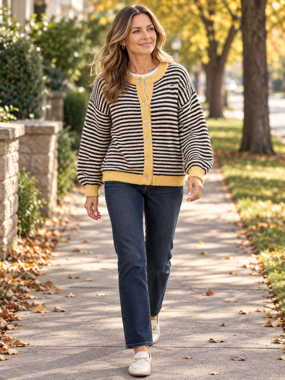 Woman wearing the striped cardigan on an autumn neighborhood walk