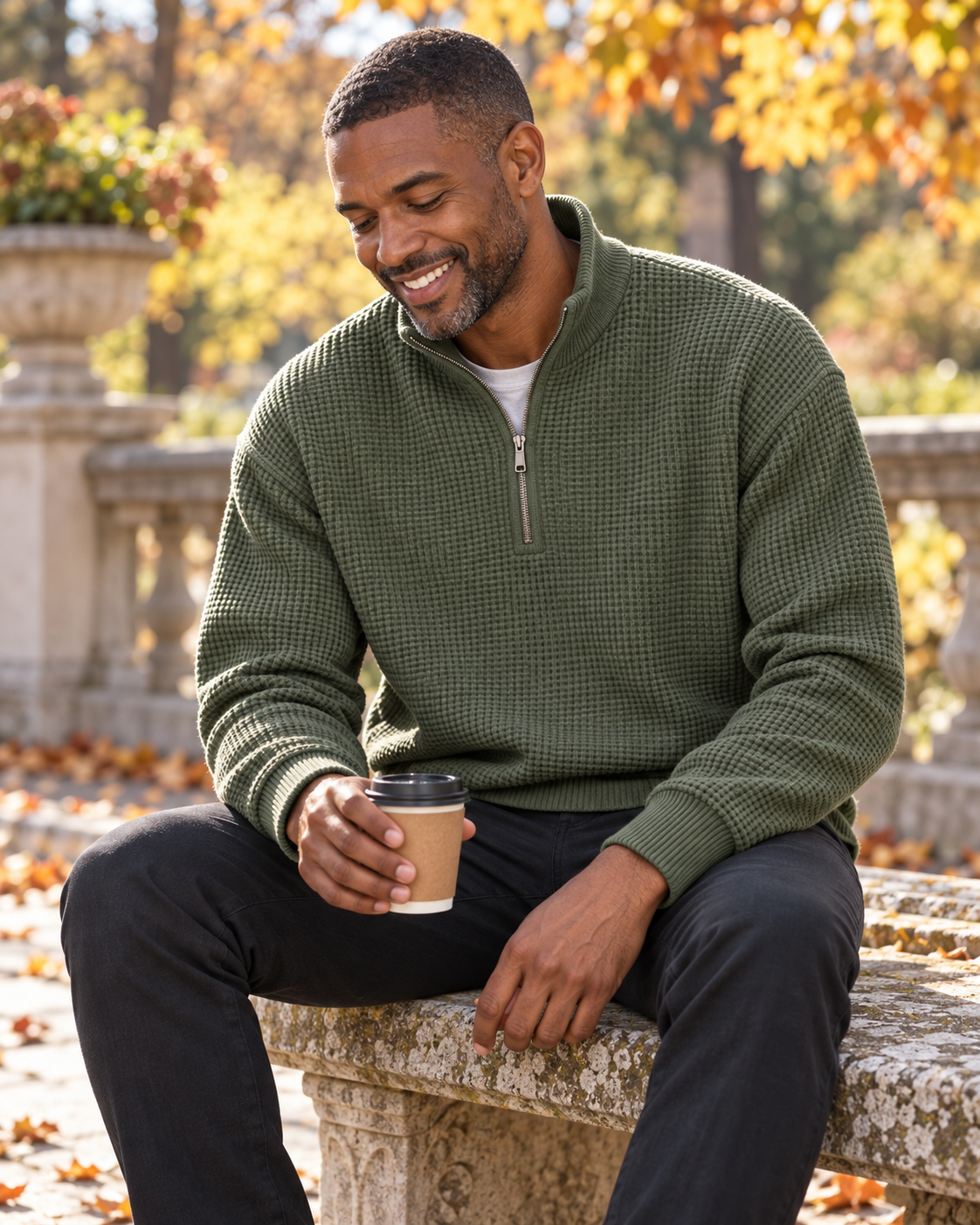 Illustrative olive waffle-knit half-zip styling outdoors with coffee