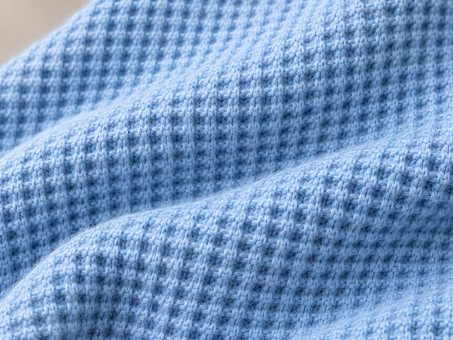 Illustrative macro view of the raised waffle-knit surface