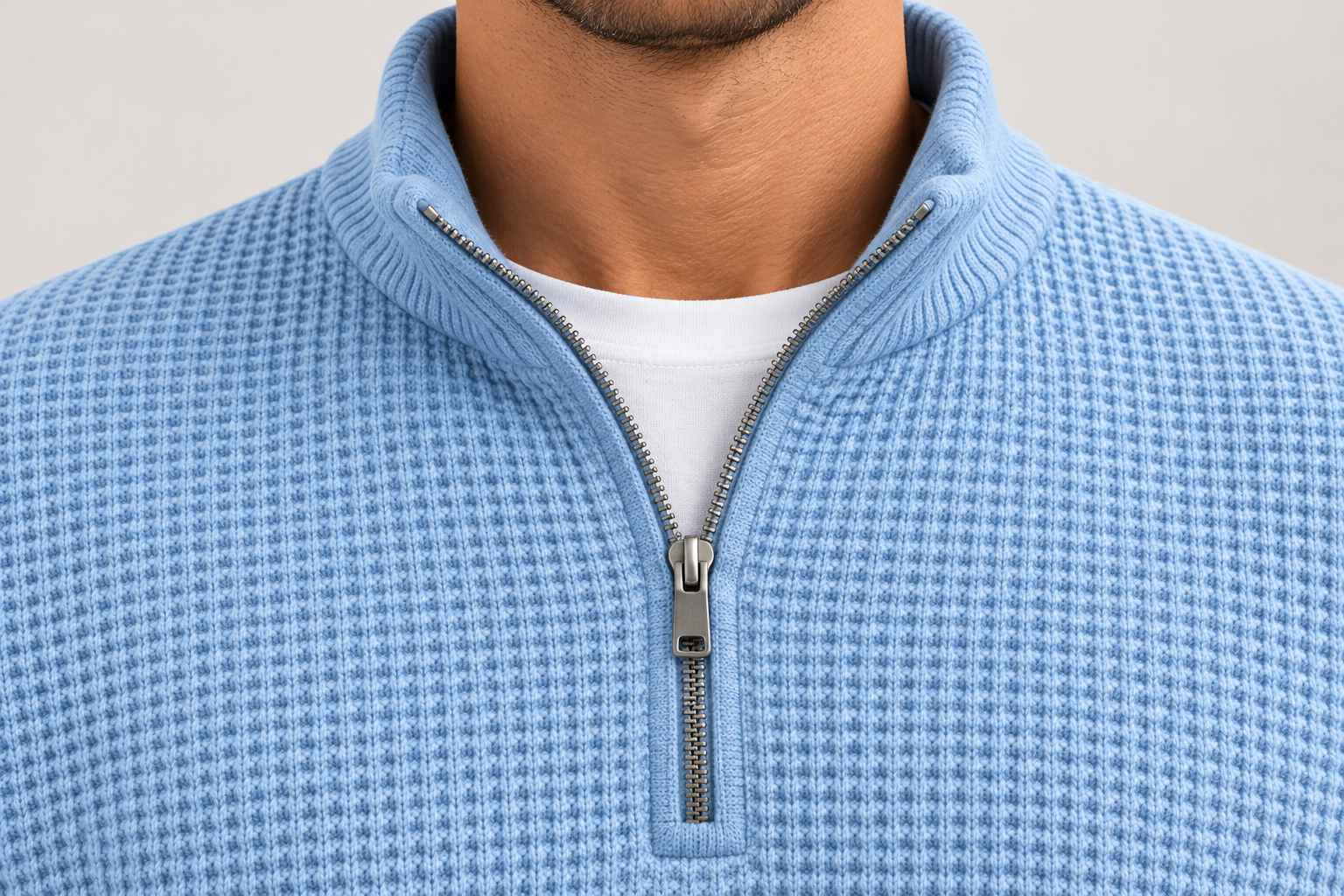 Illustrative close-up of the stand collar and half-zip finish