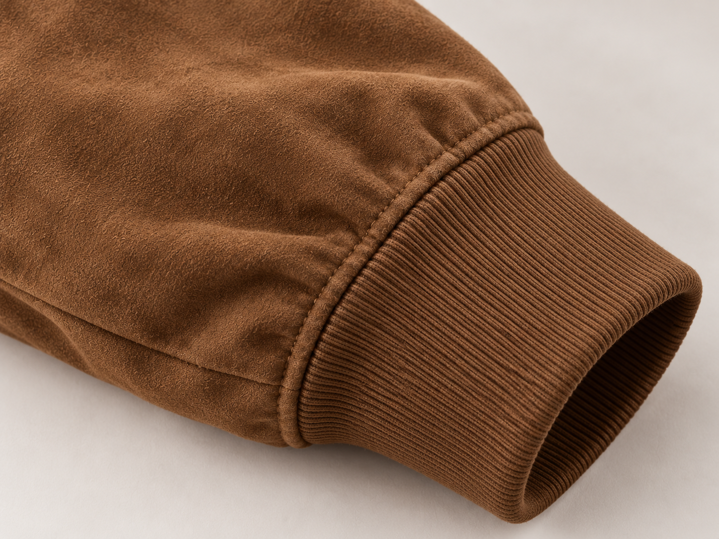 Close-up illustration of the suede-finish sleeve meeting a rib-knit cuff