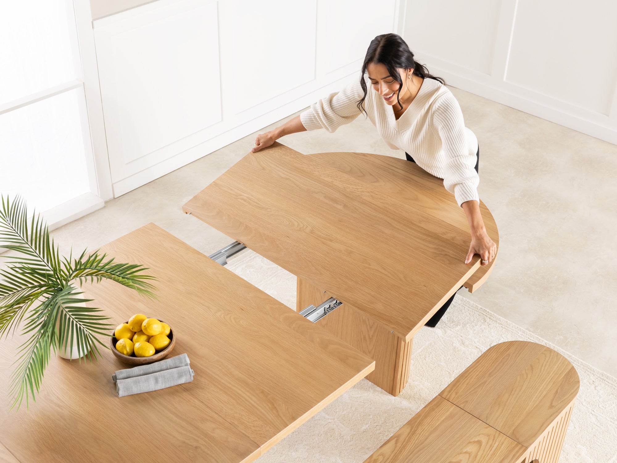 Versatile expandable dining table seats 4‑10, robust hardwood‑steel build, hidden pedestal storage and elegant fluted detailing for flexible everyday dining.