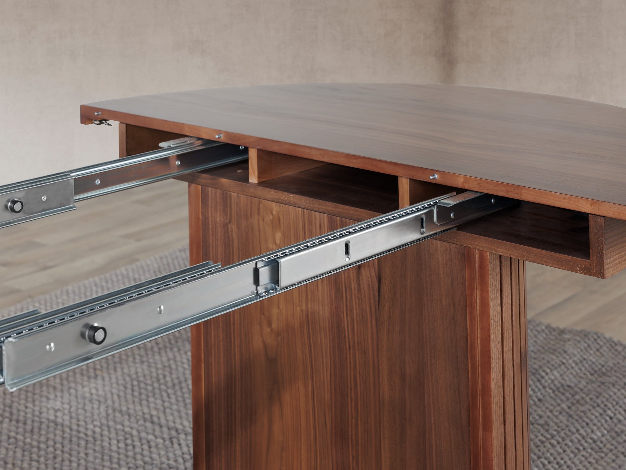 Versatile expandable dining table seats 4‑10, robust hardwood‑steel build, hidden pedestal storage and elegant fluted detailing for flexible everyday dining.