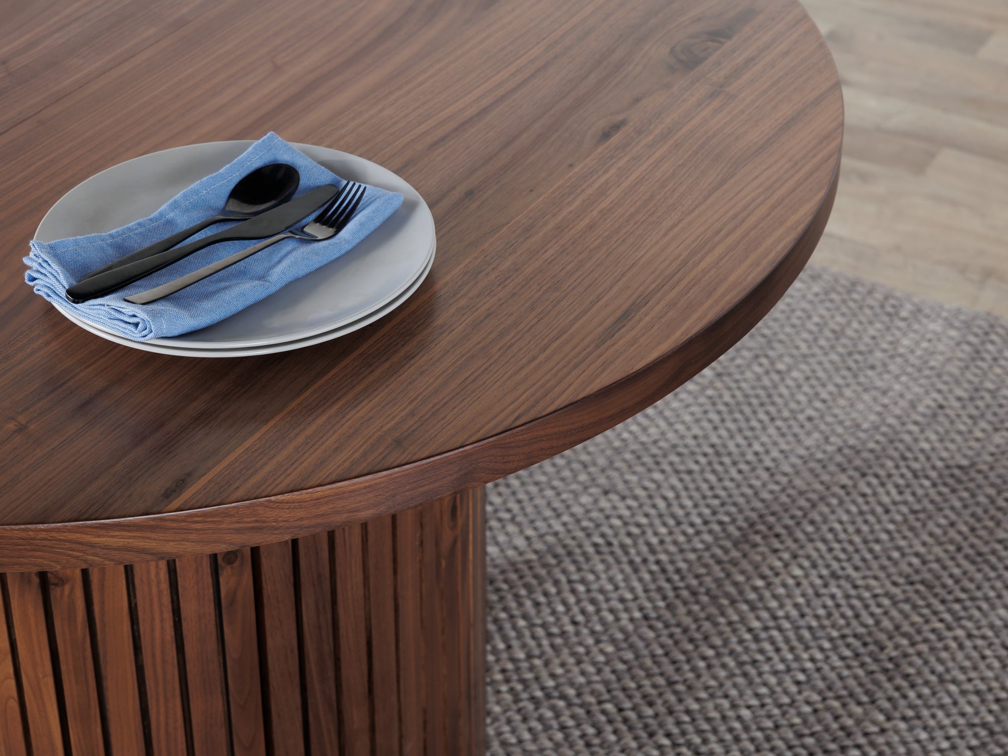 Versatile expandable dining table seats 4‑10, robust hardwood‑steel build, hidden pedestal storage and elegant fluted detailing for flexible everyday dining.