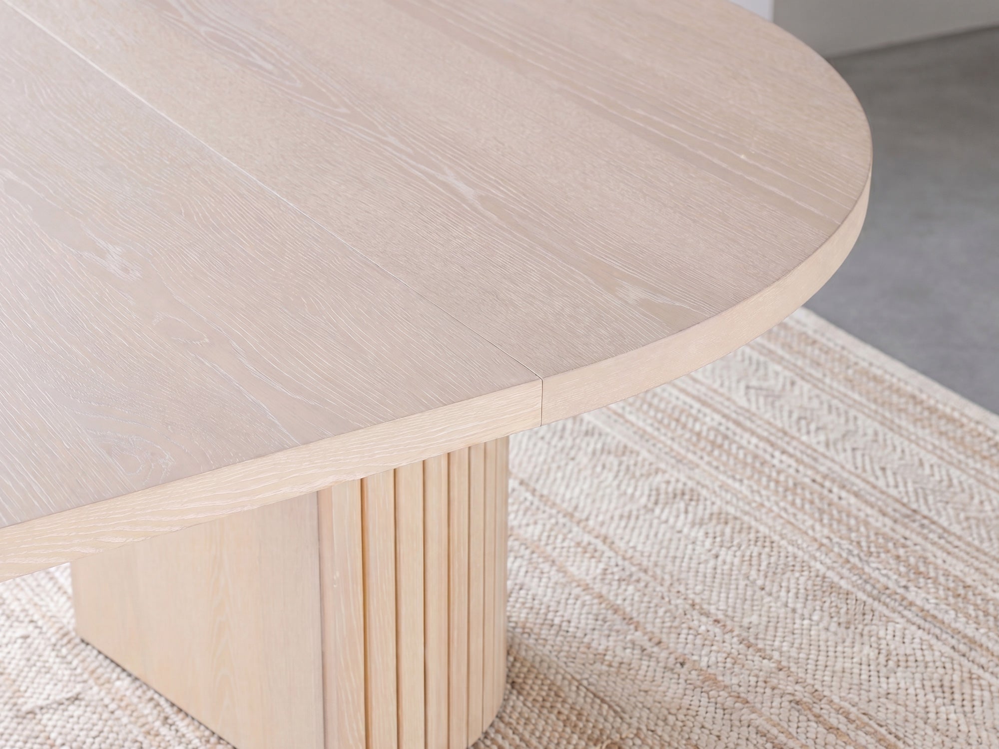 Versatile expandable dining table seats 4‑10, robust hardwood‑steel build, hidden pedestal storage and elegant fluted detailing for flexible everyday dining.