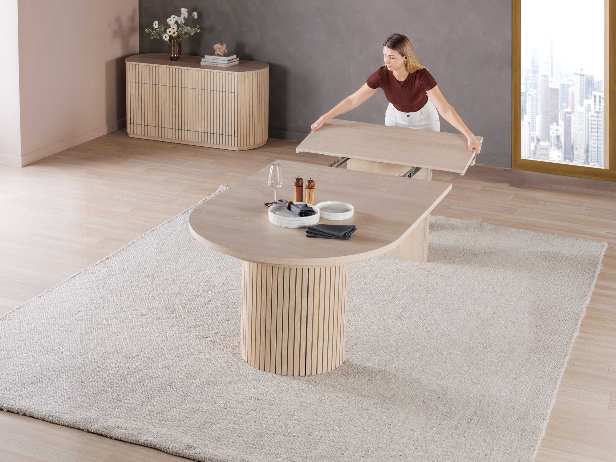 Versatile expandable dining table seats 4‑10, robust hardwood‑steel build, hidden pedestal storage and elegant fluted detailing for flexible everyday dining.