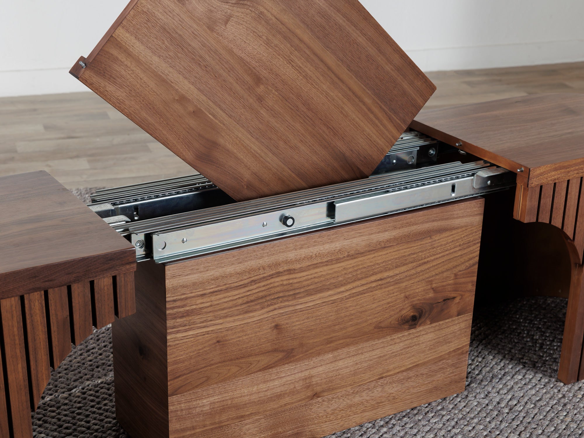 Practical extendable round dining set; storage‑built bench holds extra panels, robust hardwood build, smooth gliding rails and matching premium finishes.