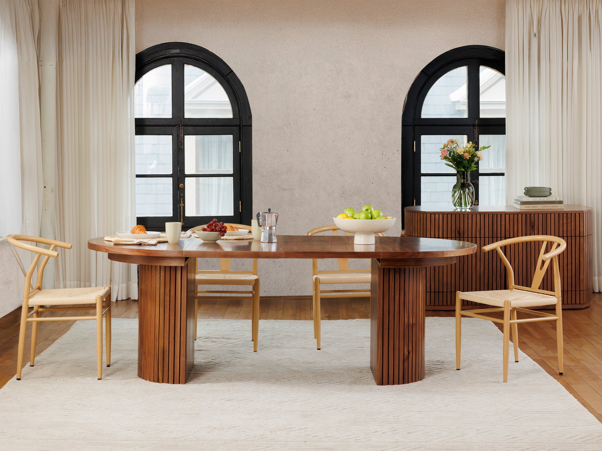 Versatile expandable dining table seats 4‑10, robust hardwood‑steel build, hidden pedestal storage and elegant fluted detailing for flexible everyday dining.