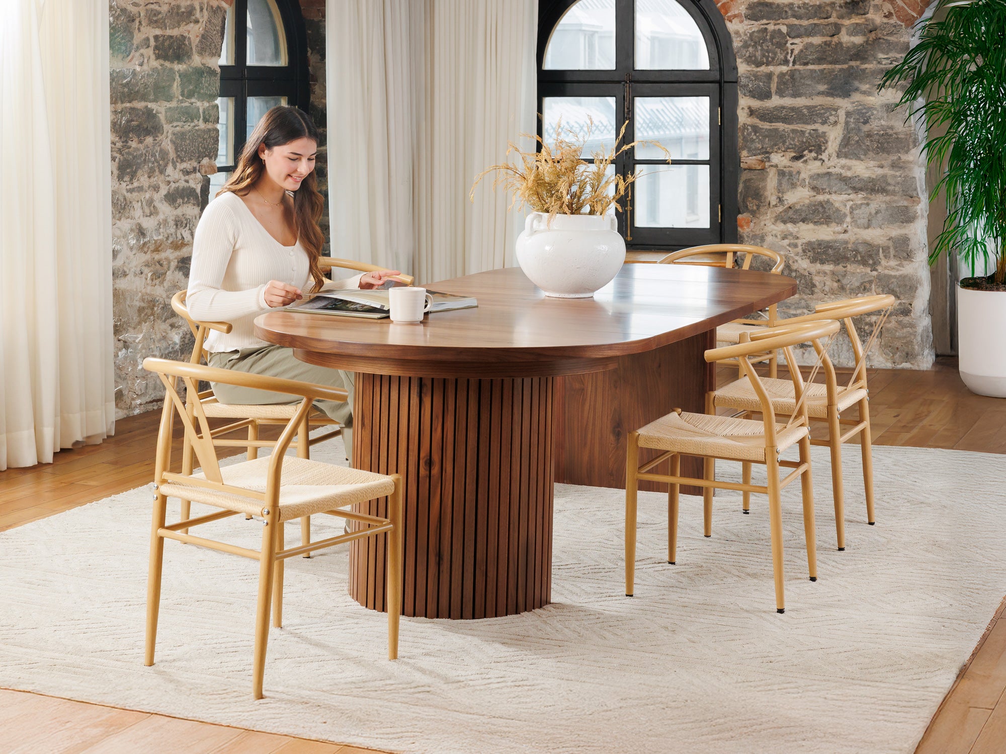 Versatile expandable dining table seats 4‑10, robust hardwood‑steel build, hidden pedestal storage and elegant fluted detailing for flexible everyday dining.