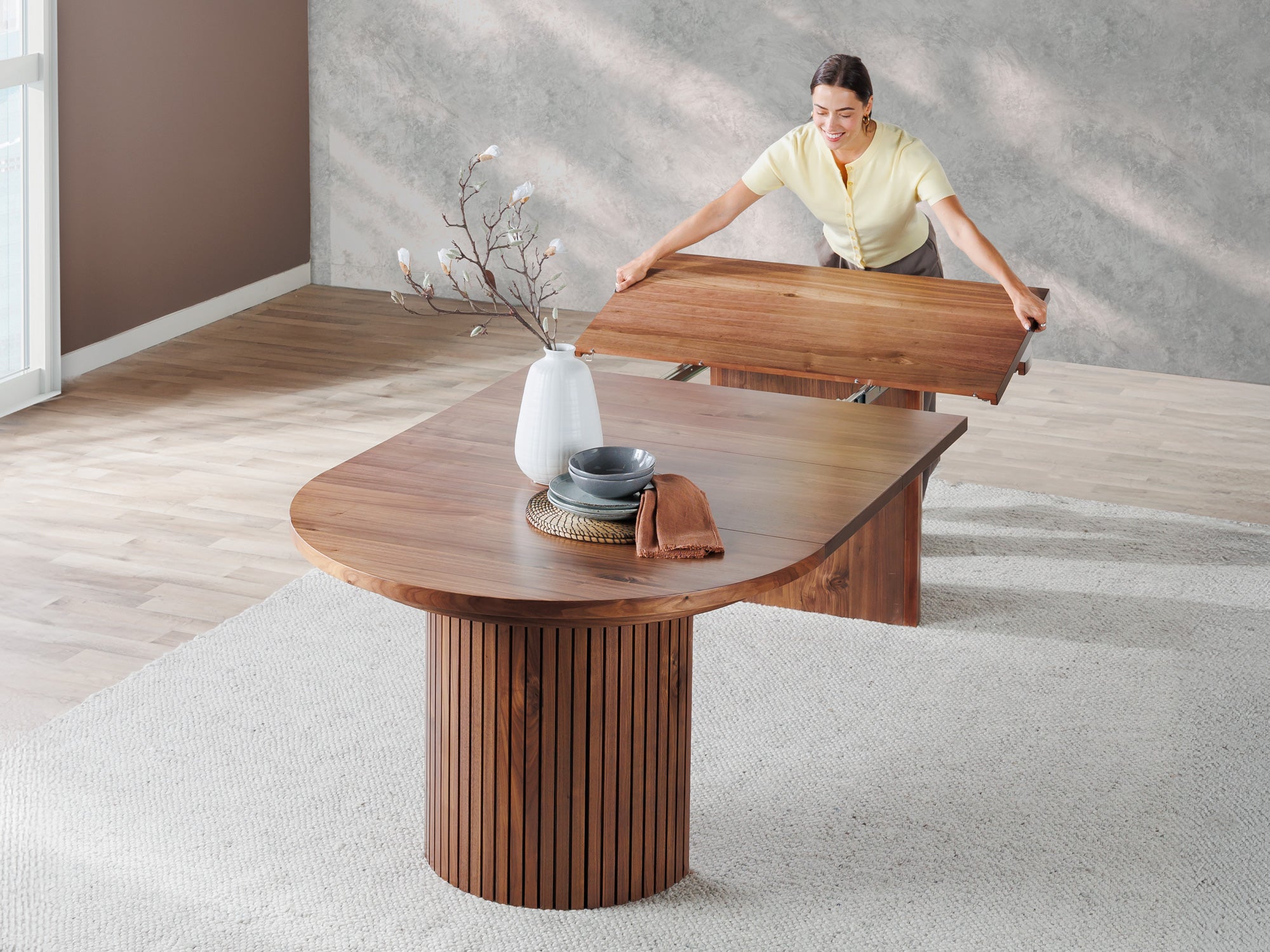 Versatile expandable dining table seats 4‑10, robust hardwood‑steel build, hidden pedestal storage and elegant fluted detailing for flexible everyday dining.