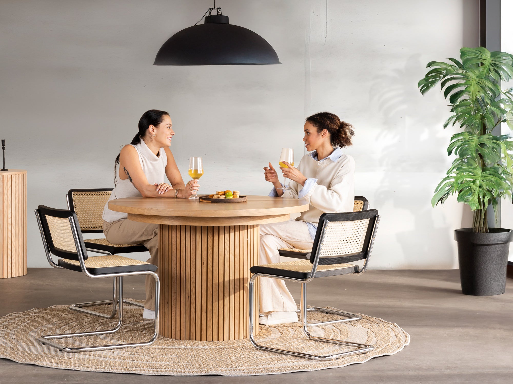 Versatile expandable dining table seats 4‑10, robust hardwood‑steel build, hidden pedestal storage and elegant fluted detailing for flexible everyday dining.