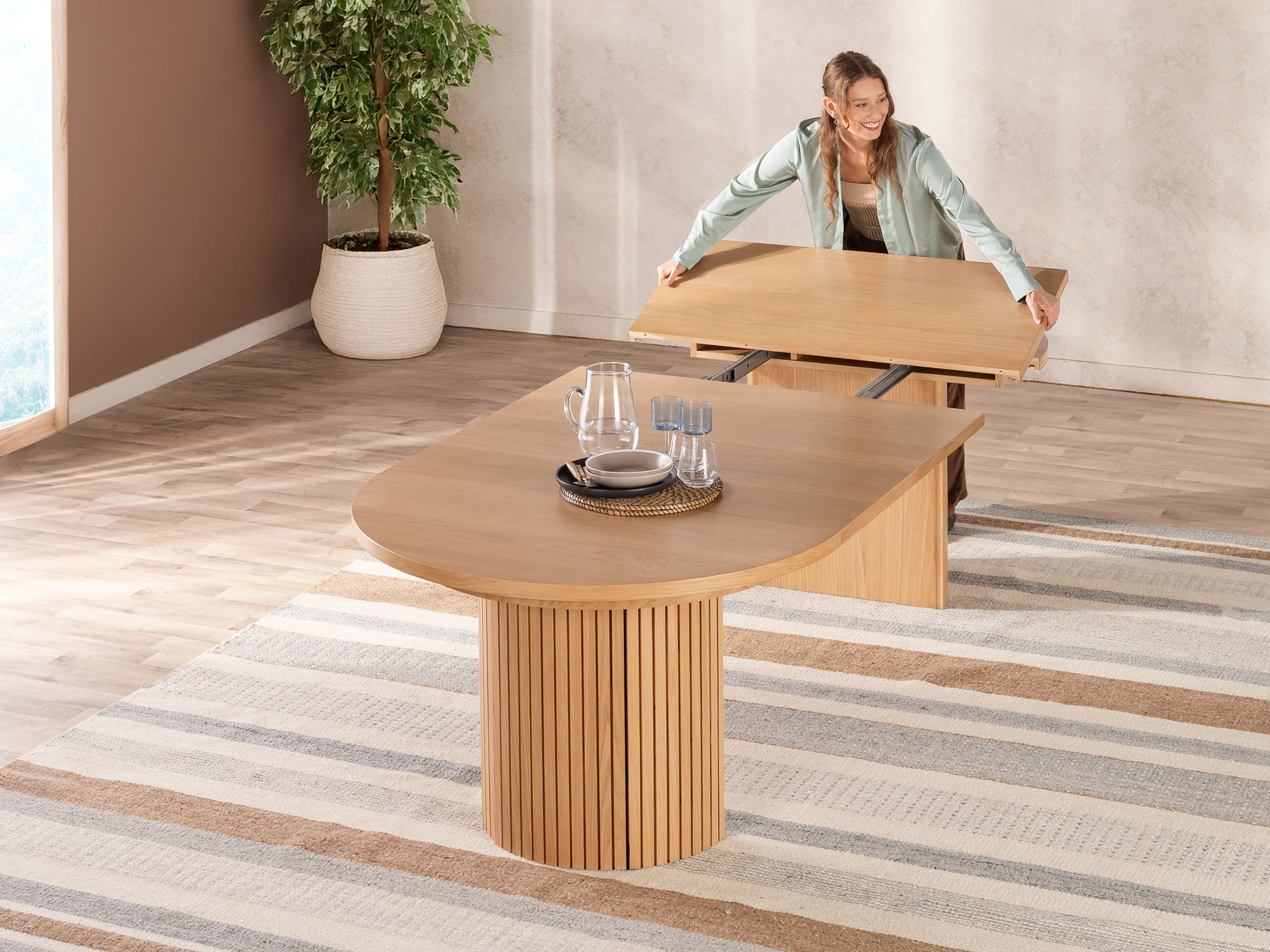 Versatile expandable dining table seats 4‑10, robust hardwood‑steel build, hidden pedestal storage and elegant fluted detailing for flexible everyday dining.