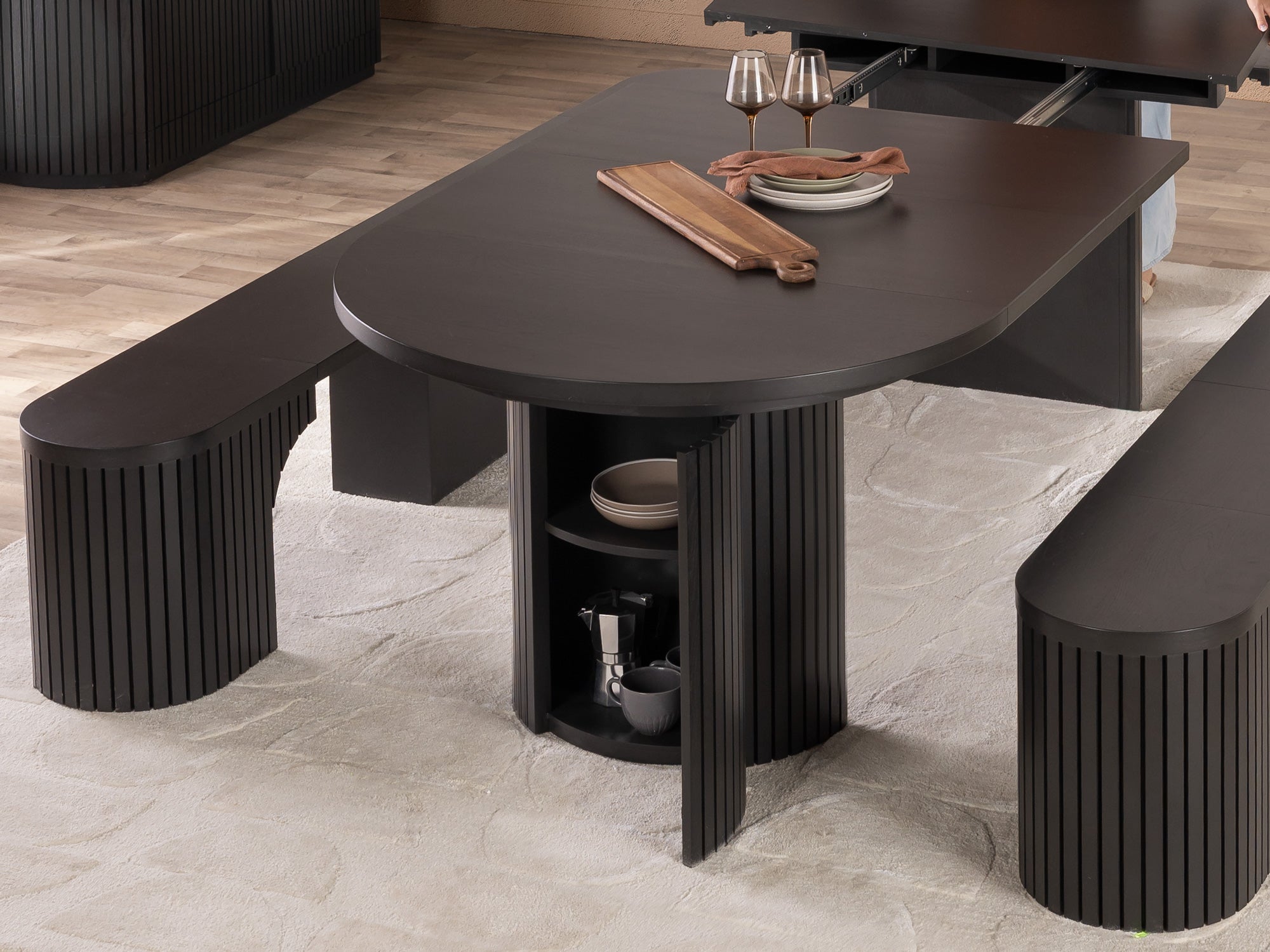 Versatile expandable dining table seats 4‑10, robust hardwood‑steel build, hidden pedestal storage and elegant fluted detailing for flexible everyday dining.