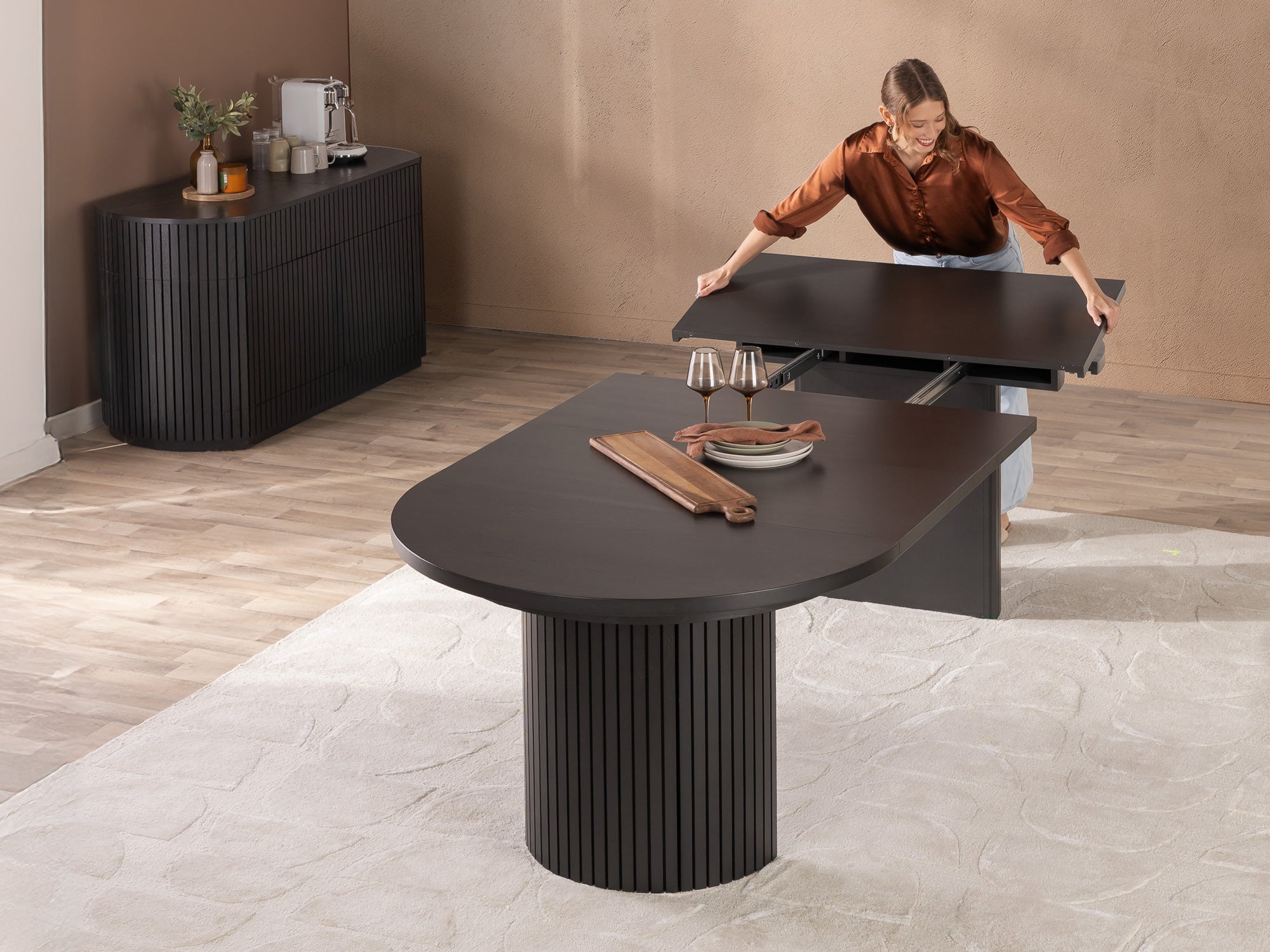 Versatile expandable dining table seats 4‑10, robust hardwood‑steel build, hidden pedestal storage and elegant fluted detailing for flexible everyday dining.