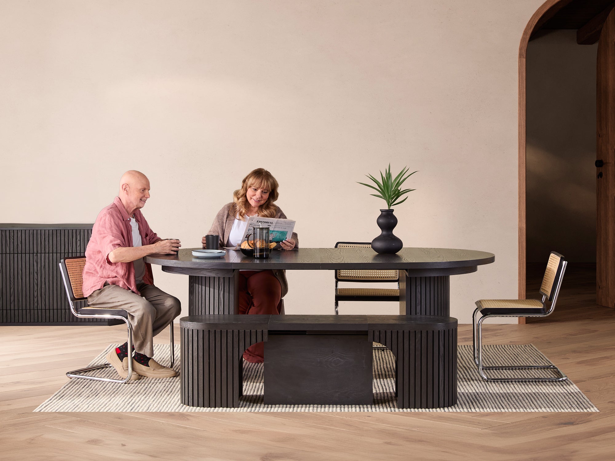 Versatile expandable dining table seats 4‑10, robust hardwood‑steel build, hidden pedestal storage and elegant fluted detailing for flexible everyday dining.