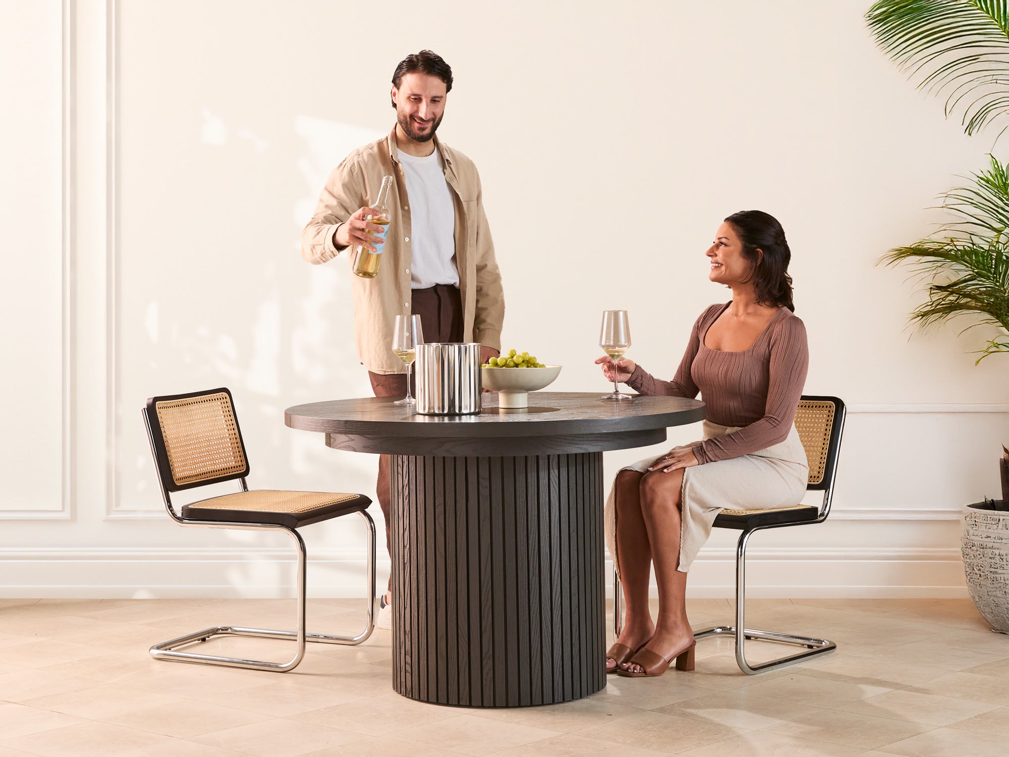 Versatile expandable dining table seats 4‑10, robust hardwood‑steel build, hidden pedestal storage and elegant fluted detailing for flexible everyday dining.