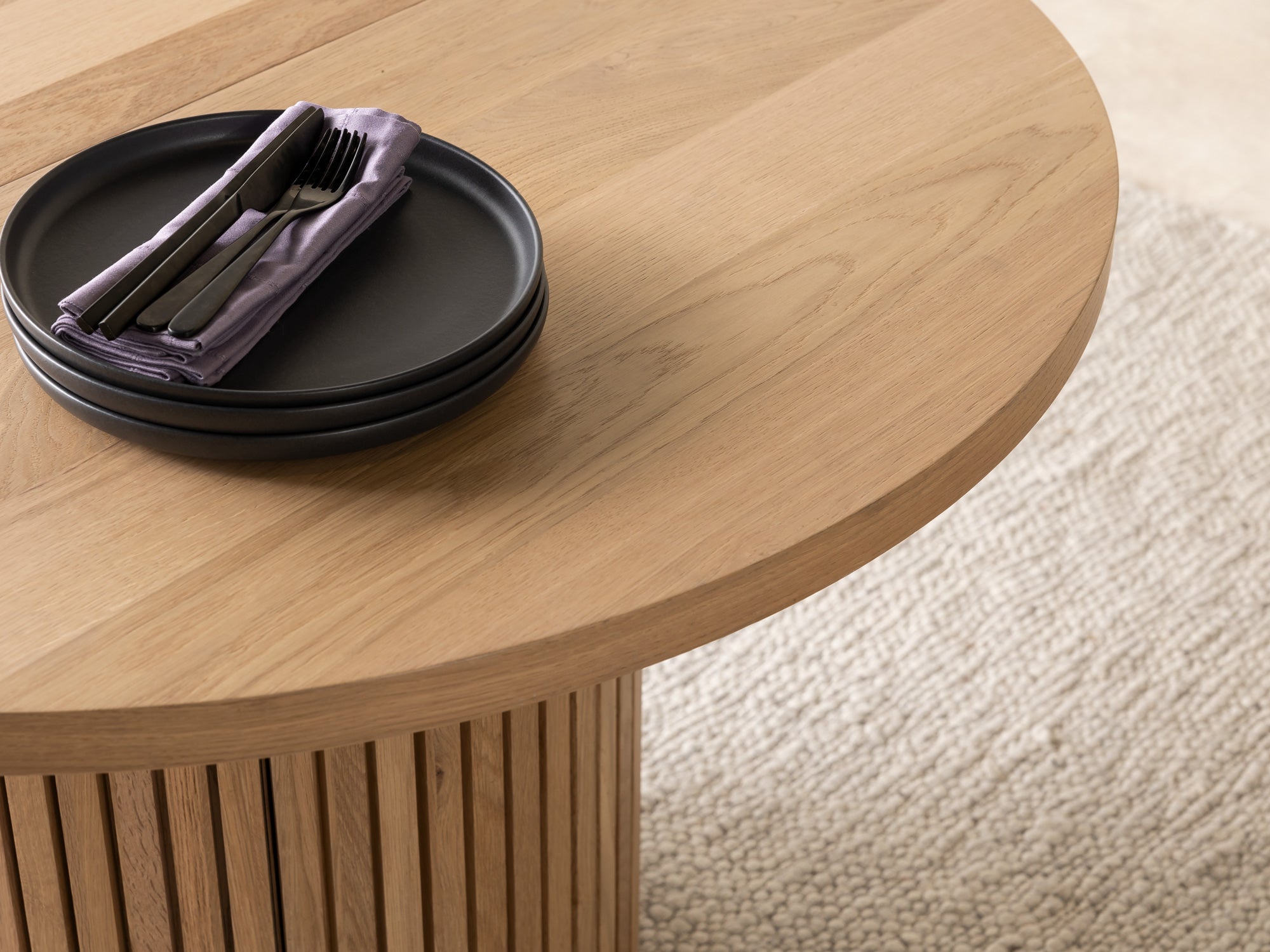 Versatile expandable dining table seats 4‑10, robust hardwood‑steel build, hidden pedestal storage and elegant fluted detailing for flexible everyday dining.