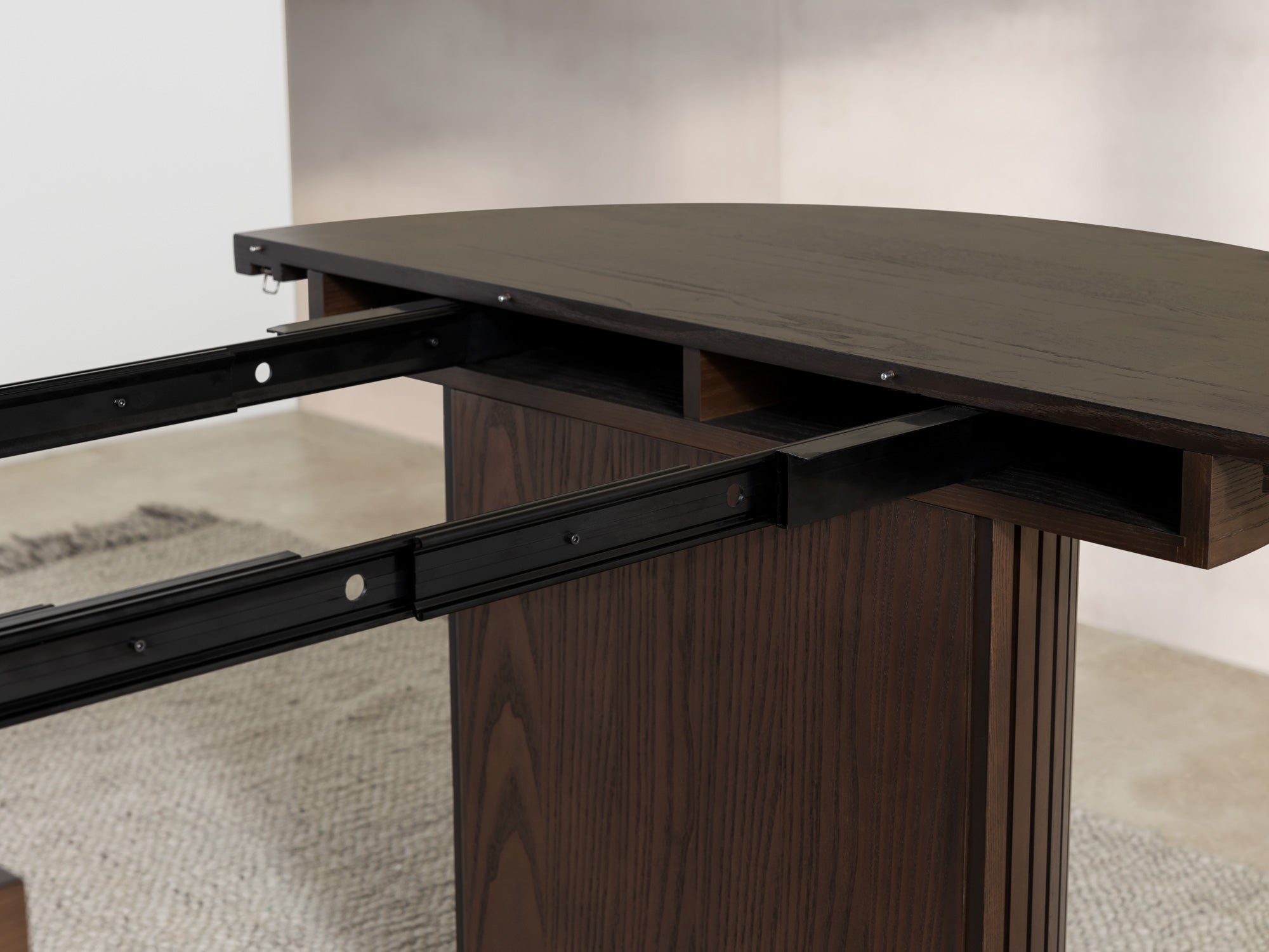 Versatile expandable dining table seats 4‑10, robust hardwood‑steel build, hidden pedestal storage and elegant fluted detailing for flexible everyday dining.