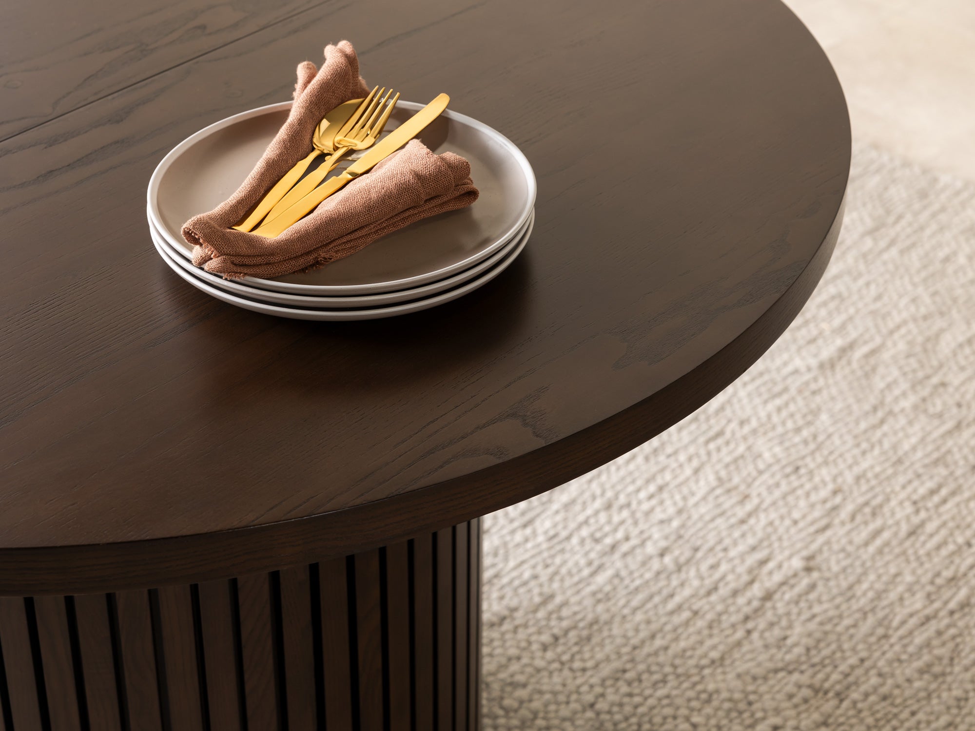 Versatile expandable dining table seats 4‑10, robust hardwood‑steel build, hidden pedestal storage and elegant fluted detailing for flexible everyday dining.