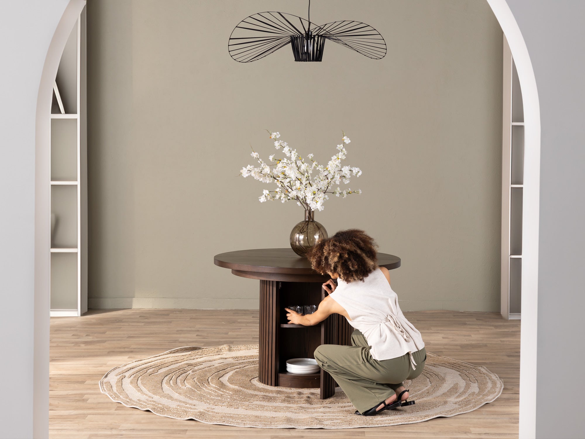 Versatile expandable dining table seats 4‑10, robust hardwood‑steel build, hidden pedestal storage and elegant fluted detailing for flexible everyday dining.