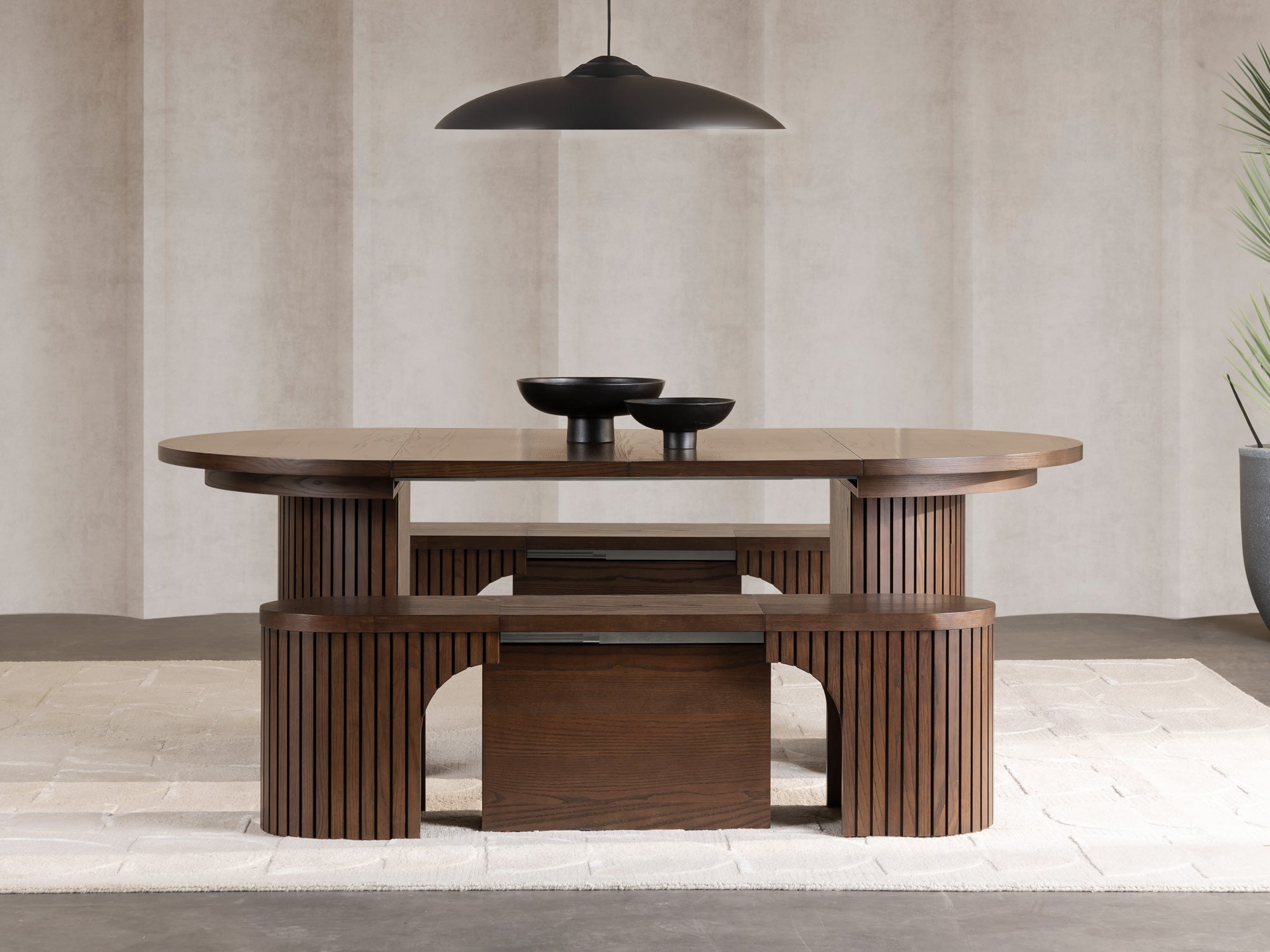 Practical extendable round dining set; storage‑built bench holds extra panels, robust hardwood build, smooth gliding rails and matching premium finishes.