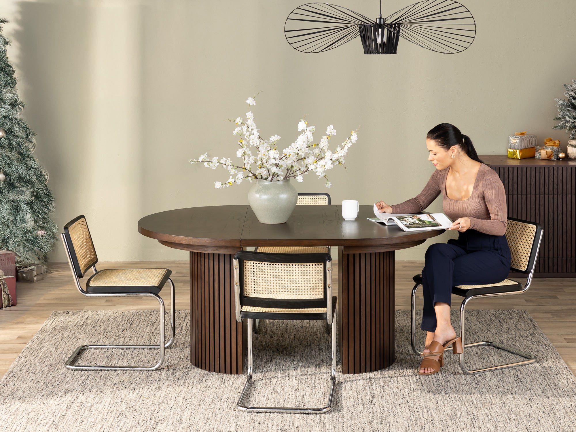 Versatile expandable dining table seats 4‑10, robust hardwood‑steel build, hidden pedestal storage and elegant fluted detailing for flexible everyday dining.