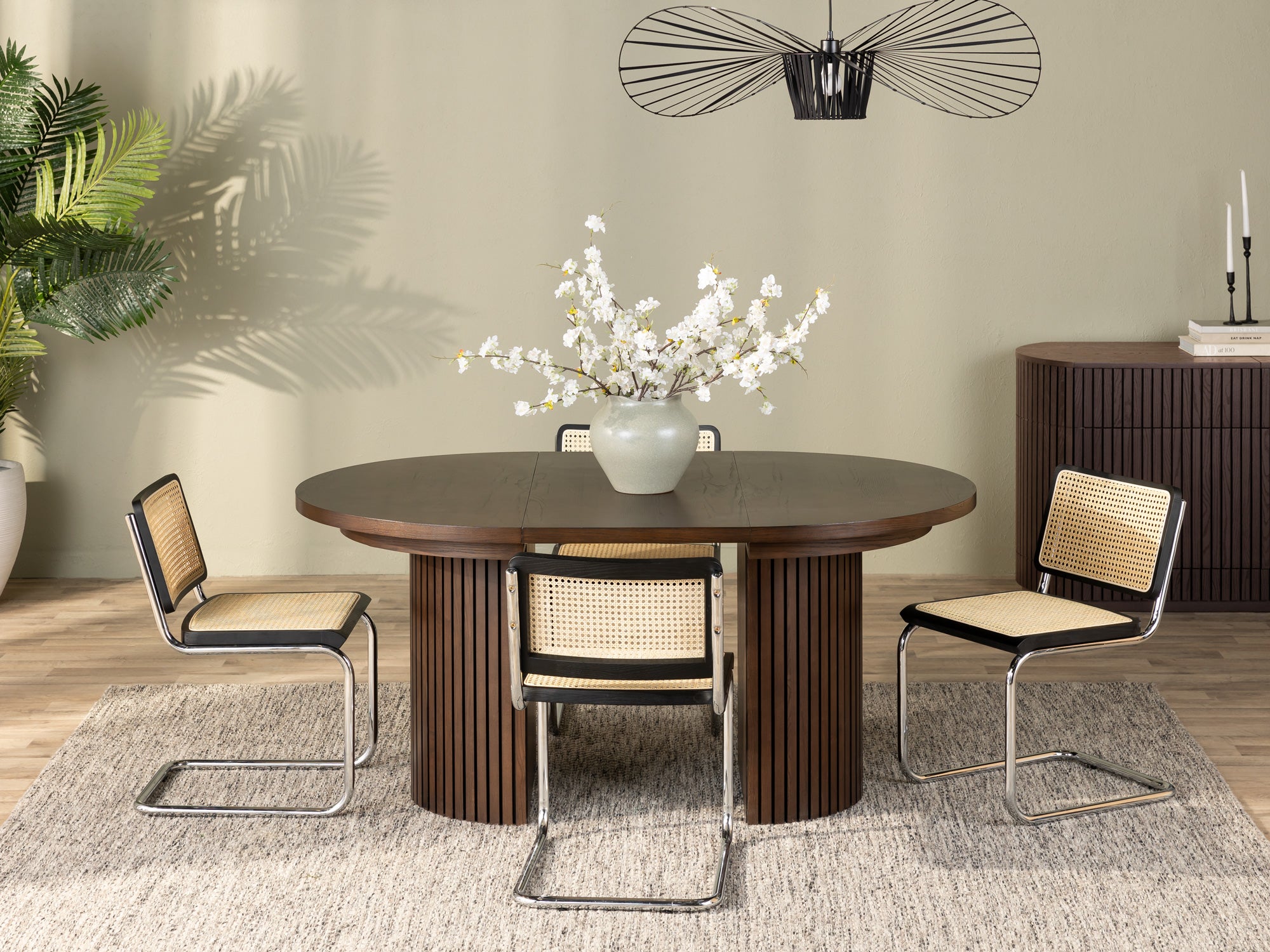 Versatile expandable dining table seats 4‑10, robust hardwood‑steel build, hidden pedestal storage and elegant fluted detailing for flexible everyday dining.